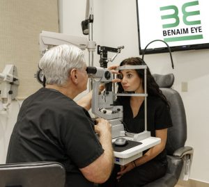 Dr Benaim with patient performing eye examination